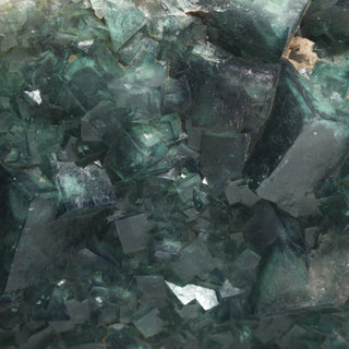 Close-up macro detail of Fluorite Cluster Unique #54, showing the interlocking translucent green fluorite cubes, colour zoning and internal fractures at full magnification. Stonebridge Imports.
