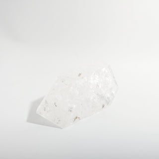 Clear Quartz Free Form Unique #1, a polished clear quartz free-form polished point shown from an alternate angle on a clean white background. Stonebridge Imports.