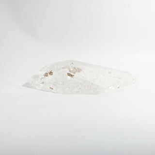Clear Quartz Free Form Unique #2, a polished clear quartz free-form polished point showing internal veils and rainbow inclusions, photographed on a clean white background. Stonebridge Imports.