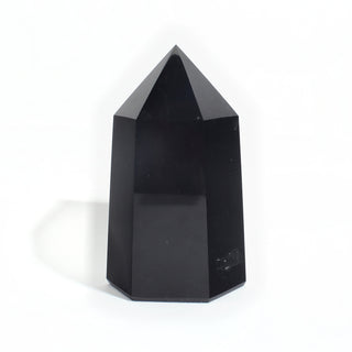 Black Obsidian Generator Unique #4 — polished six-sided tower rising to a faceted point, glossy jet-black faces, photographed on a clean white background. Stonebridge Imports.