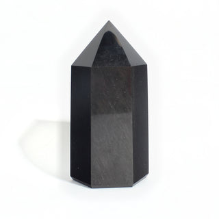 Black Obsidian Generator Unique #5 — polished six-sided tower rising to a faceted point, glossy jet-black faces, photographed on a clean white background. Stonebridge Imports.