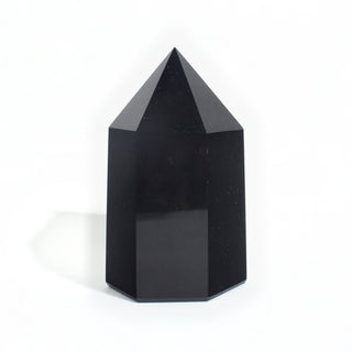 Black Obsidian Generator Unique #8 — polished six-sided tower rising to a faceted point, glossy jet-black faces, photographed on a clean white background. Stonebridge Imports.