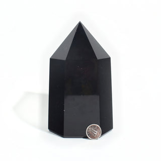 Black Obsidian Generator Unique #8 — polished six-sided tower with a faceted point, beside a Canadian dime for scale, photographed on a clean white background. Stonebridge Imports.