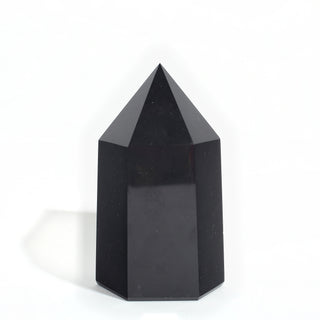 Black Obsidian Generator Unique #8 — polished six-sided tower with a faceted point, seen from a second angle, photographed on a clean white background. Stonebridge Imports.