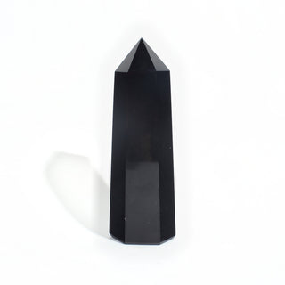 Black Obsidian Generator Unique #9 — polished six-sided tower rising to a faceted point, glossy jet-black faces, photographed on a clean white background. Stonebridge Imports.