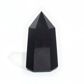 Black Obsidian Generator Unique #12 — polished six-sided tower rising to a faceted point, glossy jet-black faces, photographed on a clean white background. Stonebridge Imports.