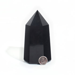 Black Obsidian Generator Unique #12 — polished six-sided tower with a faceted point, beside a Canadian dime for scale, photographed on a clean white background. Stonebridge Imports.