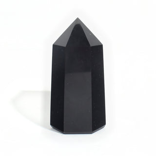 Black Obsidian Generator Unique #13 — polished six-sided tower rising to a faceted point, glossy jet-black faces, photographed on a clean white background. Stonebridge Imports.