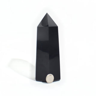 Black Obsidian Generator Unique #15 — polished six-sided tower with a faceted point, beside a Canadian dime for scale, photographed on a clean white background. Stonebridge Imports.