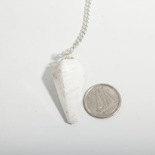 Scolecite Pendulum 6 Facet & Bead - 3 Pack, one milky white scolecite pendulum beside a dime for scale, on a clean white background. Stonebridge Imports.