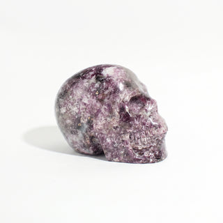 Lepidolite Skull Carving Unique #9, alternate angle photographed on a clean white background. Stonebridge Imports.