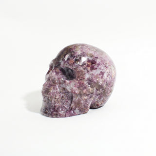 Lepidolite Skull Carving Unique #9, alternate angle photographed on a clean white background. Stonebridge Imports.