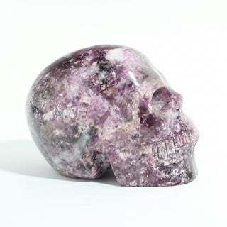 Lepidolite Skull Carving Unique #9, alternate angle photographed on a clean white background. Stonebridge Imports.