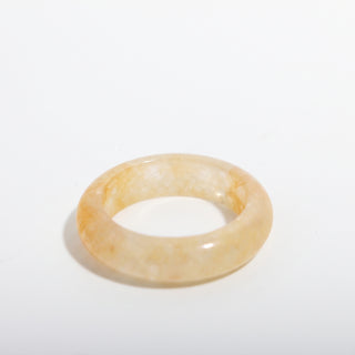 Golden Healer Ring — solid pale golden healer quartz stone band ring, alternate angle photographed on a clean white background. Stonebridge Imports.
