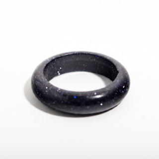 Blue Goldstone Ring (Enhanced) — solid deep blue goldstone with fine sparkle stone band ring, alternate angle photographed on a clean white background. Stonebridge Imports.