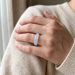 Opalite Ring worn on the hand in natural light, showing the solid milky blue-white opalite band at true scale.