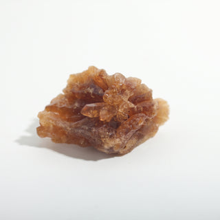 1 1/2" — Natural Citrine - Morocco, a low cluster with a spray of translucent amber crystal points in the centre, photographed on a clean white background. Stonebridge Imports.