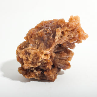 2" — Natural Citrine - Morocco, a larger amber and tan crystal cluster with a rugged, cave-like crystalline face, photographed on a clean white background. Stonebridge Imports.