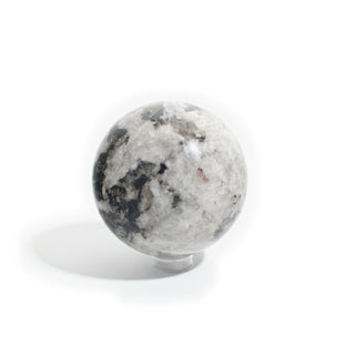 Black Tourmaline and Smoky Quartz Sphere Unique #1, cloudy white and smoky grey quartz patched with black tourmaline, photographed on a clean white background. Stonebridge Imports.