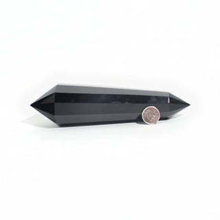 Black Obsidian Vogel Wand - 6" — double-terminated wand, sharpened at both ends, beside a Canadian dime for scale, photographed on a clean white background. Stonebridge Imports.