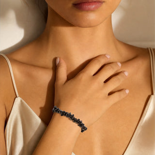 Black Agate bead bracelet worn with the hand resting on the chest