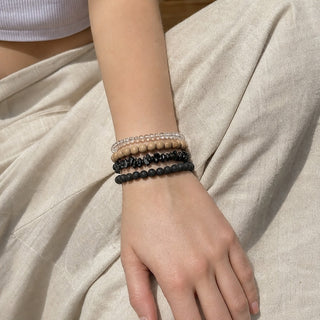 Black Agate bead bracelet stacked with other bead bracelets on the wrist
