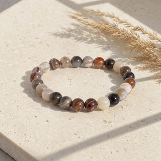 Botswana Agate bead bracelet resting on a stone slab