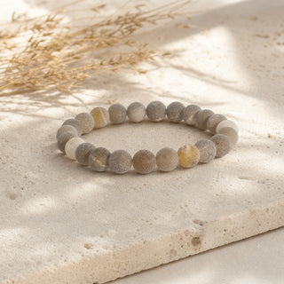 Druzy Agate bead bracelet resting on a stone slab