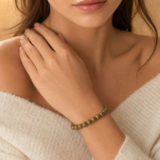 Gold Druzy Agate bead bracelet worn with the fingertips resting at the collarbone
