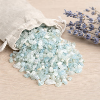 Aquamarine B Tumbled Stones - Semi Polished spilling from a linen pouch
