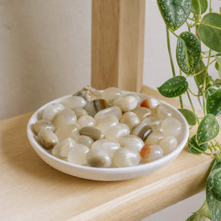 Aragonite Grey Tumbled Stones in a stoneware dish on a shop shelf