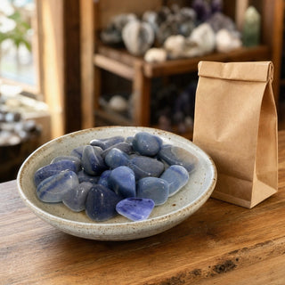 Blue Aventurine Tumbled Stones in a ceramic bowl on a shop counter