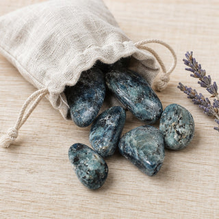 Blue/Green Kyanite Tumbled Stones spilling from a linen pouch