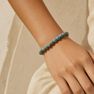 Blue Impression Jasper bead bracelet worn on the wrist, close-up