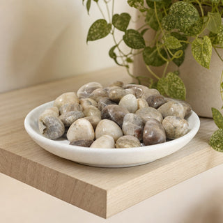 Blue Moonstone Tumbled Stones in a stoneware dish on a shop shelf
