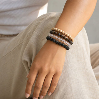 Bronzite bead bracelet stacked with other bead bracelets on the wrist