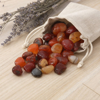 Carnelian Red Agate Tumbled Stones spilling from a linen pouch