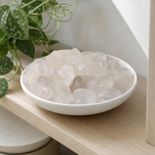 Clear Quartz B Tumbled Stones in a stoneware dish on a shop shelf