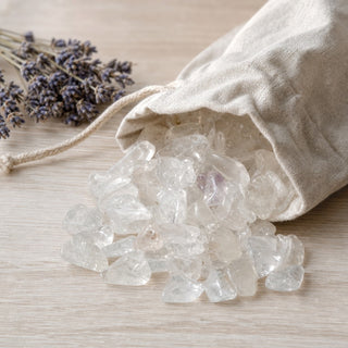 Clear Quartz B Tumbled Stones - Semi-Polished spilling from a linen pouch