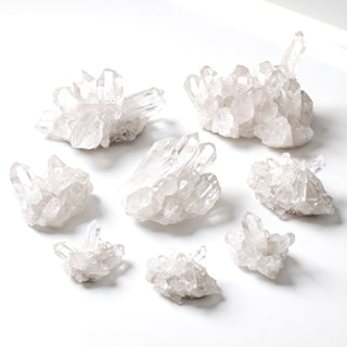 Assortment of natural Brazilian clear quartz 'A' clusters in mini to large sizes on a white background