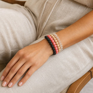 Pink Coral bead bracelet stacked with other bead bracelets on the wrist