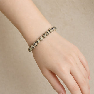 Dalmatian Jasper bead bracelet worn on the wrist, close-up