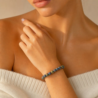Rainbow Druzy Agate bead bracelet worn with the fingertips resting at the collarbone