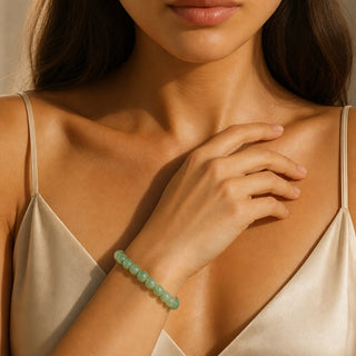 Green Aventurine bead bracelet worn with the hand resting on the chest