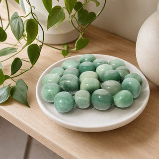 Green Aventurine Tumbled Stones - India in a stoneware dish on a shop shelf