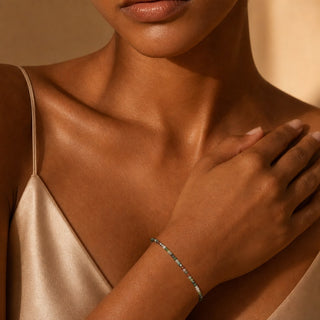 Indian Agate bead bracelet worn with the hand resting on the chest