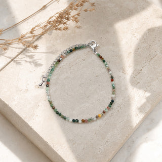 Indian Agate bead bracelet resting on a stone slab