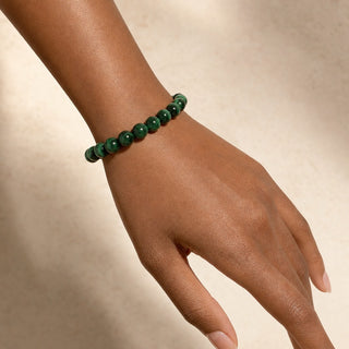 Malachite bead bracelet worn on the wrist, close-up