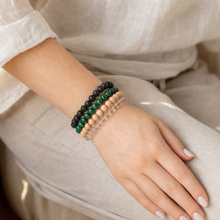 Malachite bead bracelet stacked with other bead bracelets on the wrist