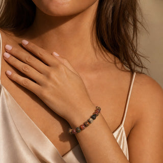 Picasso Jasper bead bracelet worn with the hand resting on the chest
